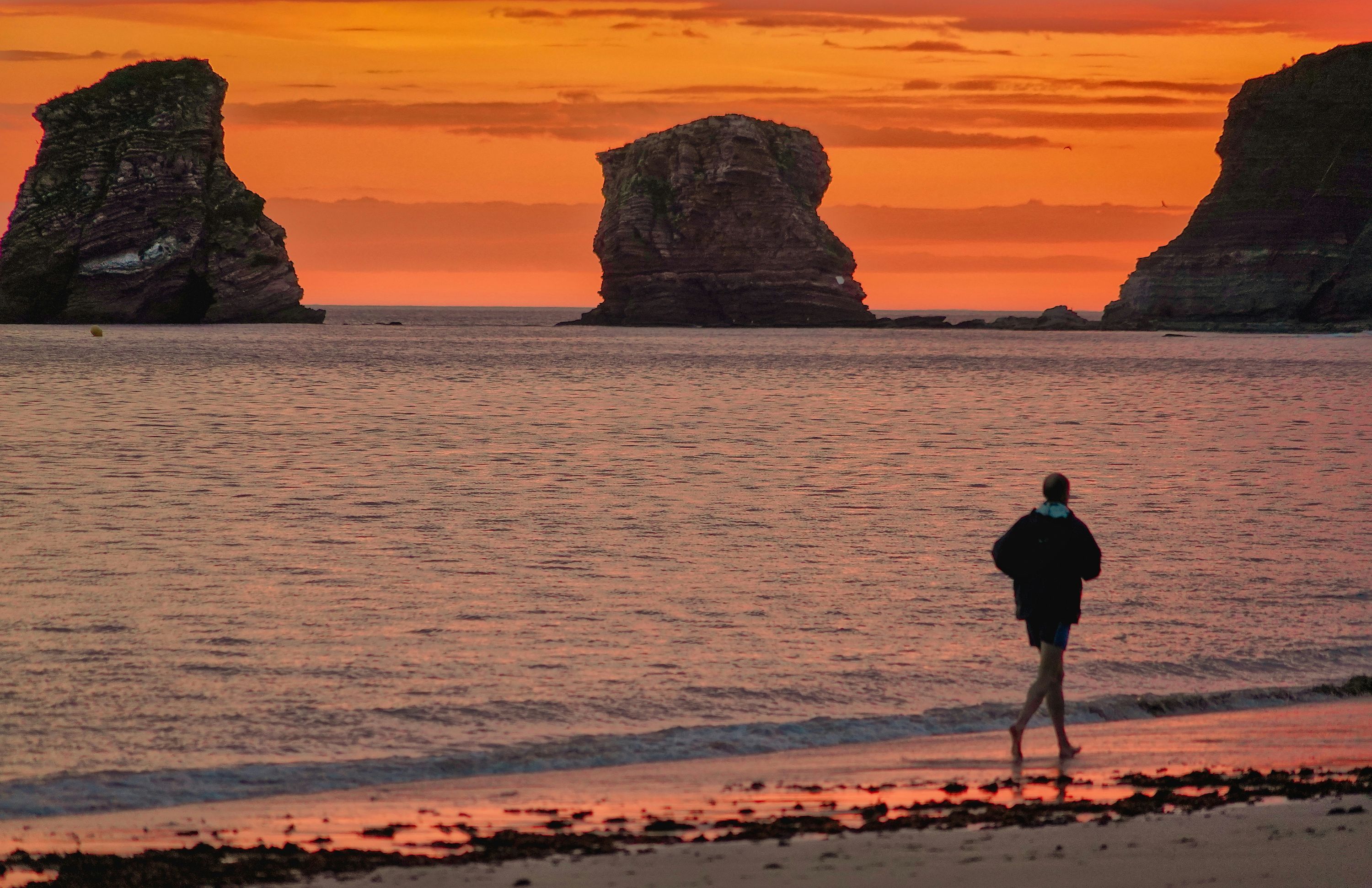 Man running barefoot on a beach